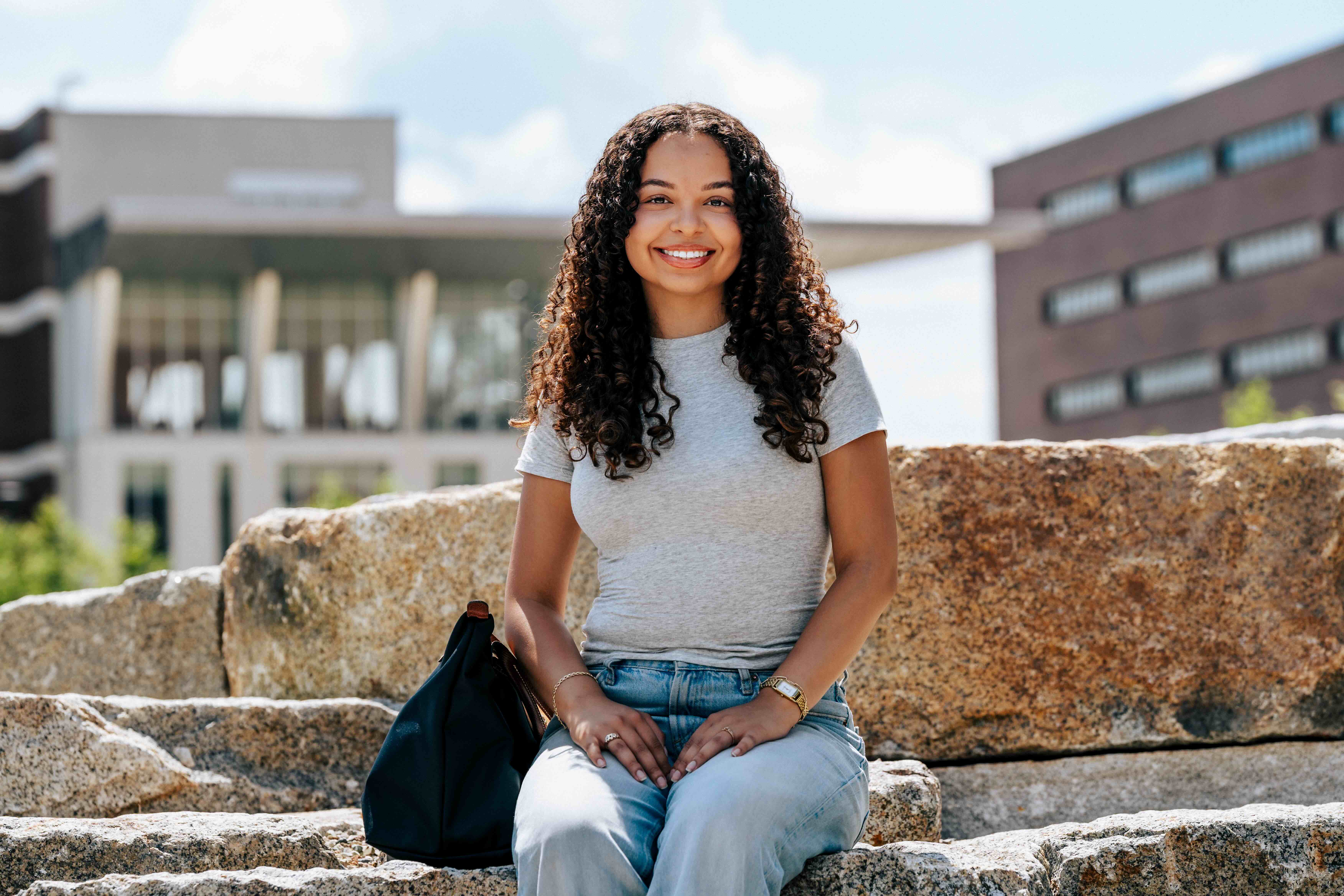 student sitting outside on quad