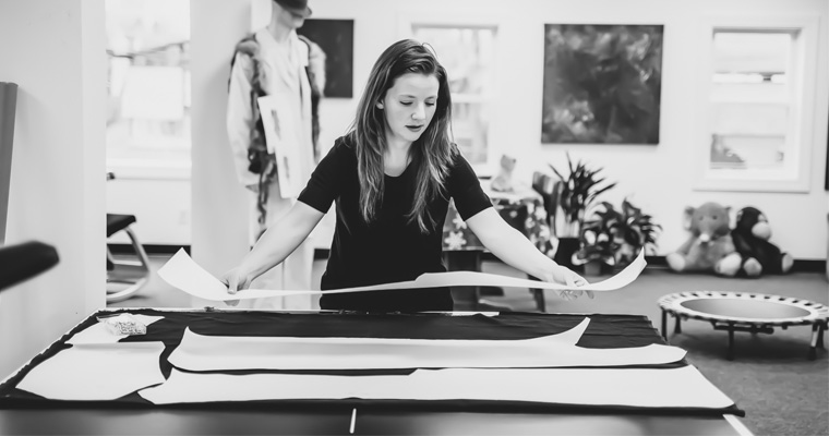 Mya Royal looking at patterns in her atelier. 