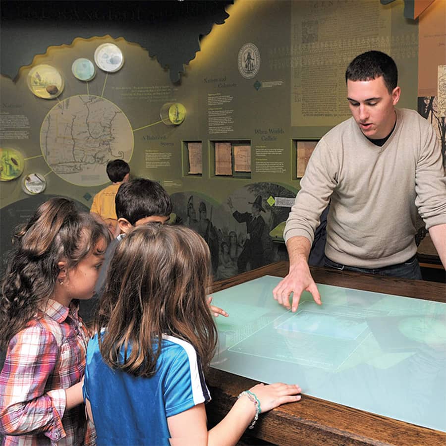 Graduate student, Phill, working with students at the Commonwealth Museum.