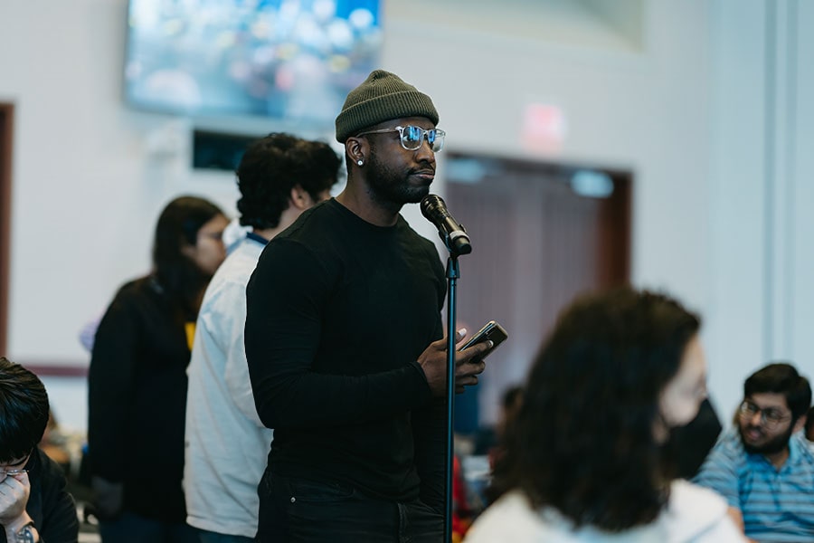 Student asks question at a conference