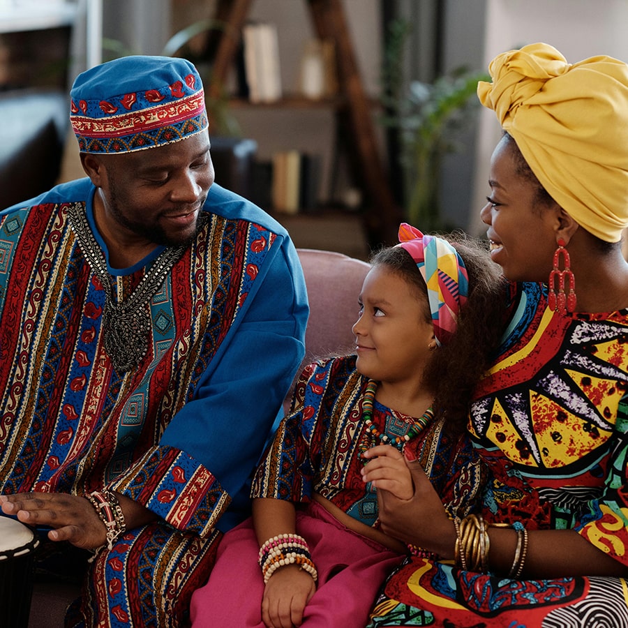 Black family in African attire celebrates Kwanzaa. Credit: Askar Abayev pexel