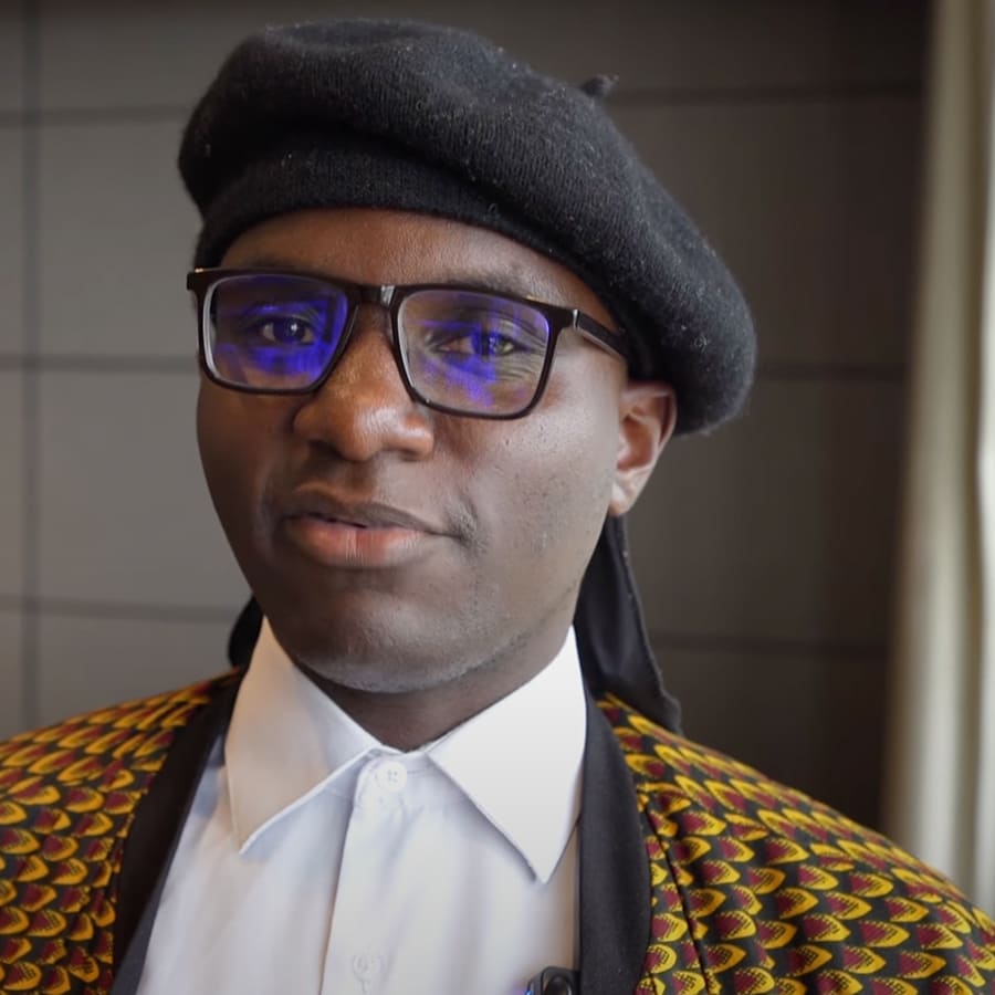 student wearing a beret inside during an interview.