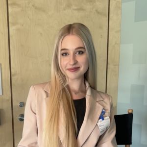 Woman with long hair and light-colored blazer